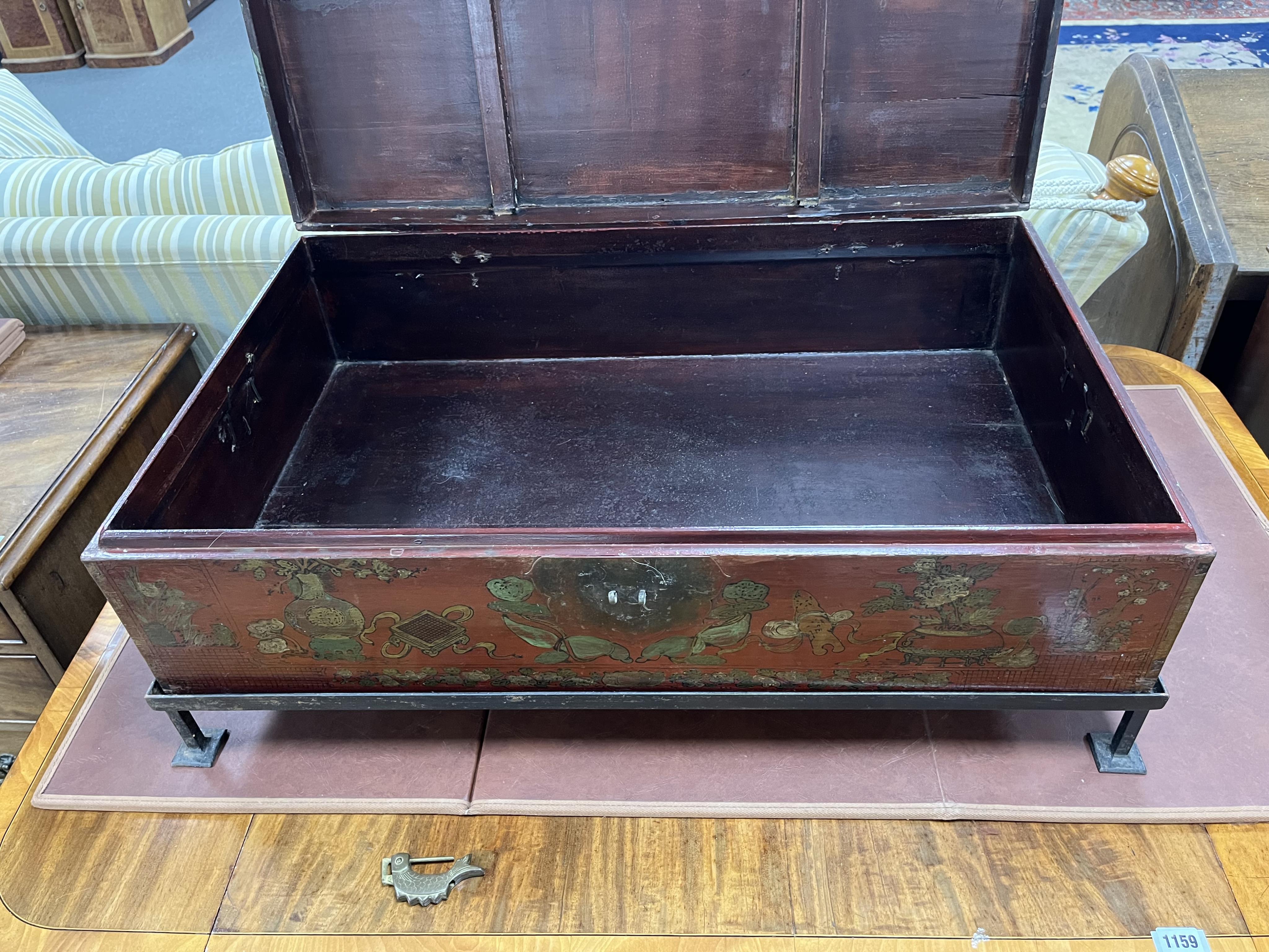 A Chinese lacquer trunk, on an associated metal stand, width 84cm, depth 53cm, height 31cm. Condition - poor